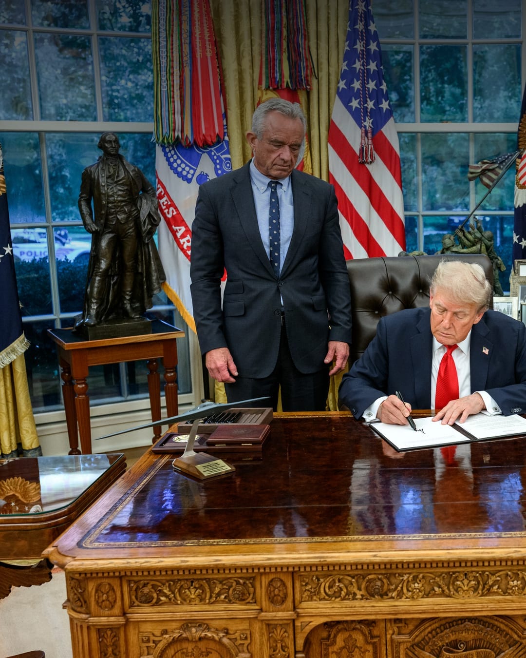 President Donald Trump signs an executive order in the Oval Office