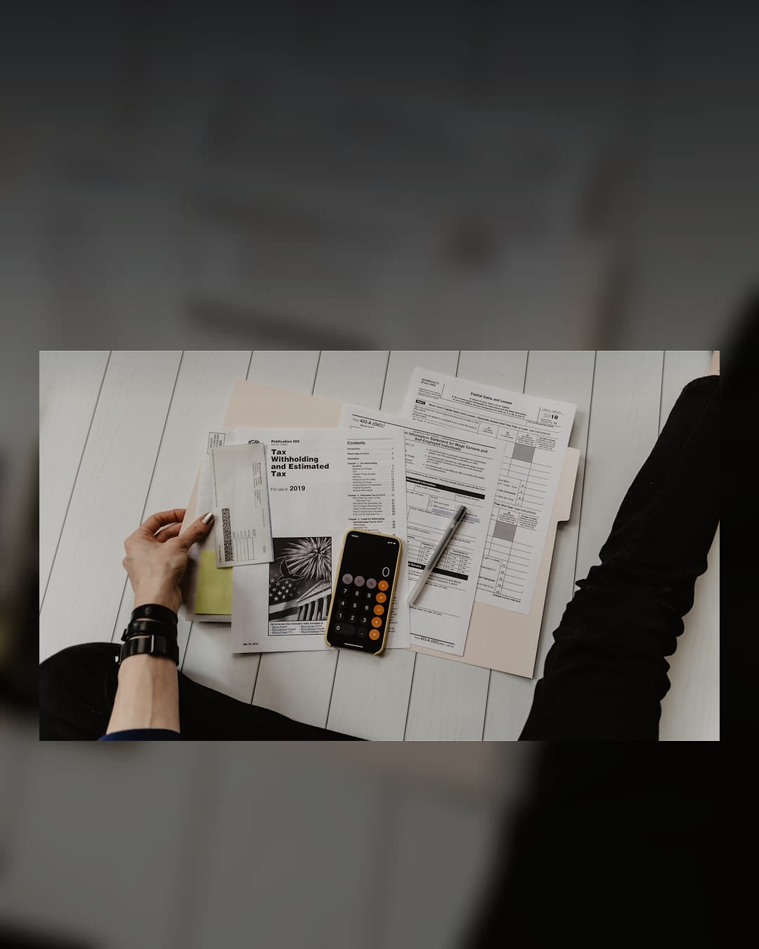 Household bills, calculator and paperwork on a desk