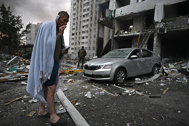 Resident outside a damaged Kyiv apartment building after Russian strikes on July 6, 2026