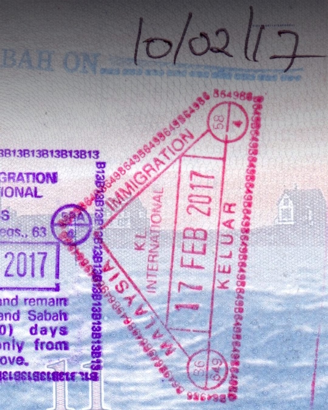 Malaysian entry and exit stamps in a passport