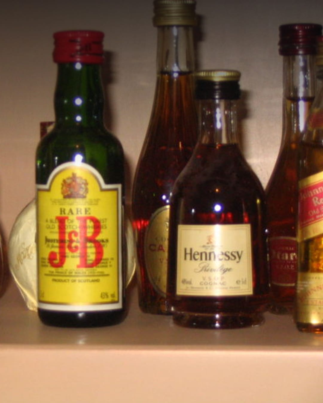 Assorted alcoholic beverage bottles and glasses