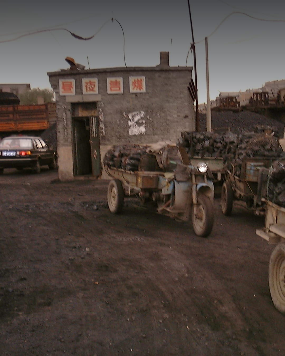 Workers charging coal at a Shanxi mine