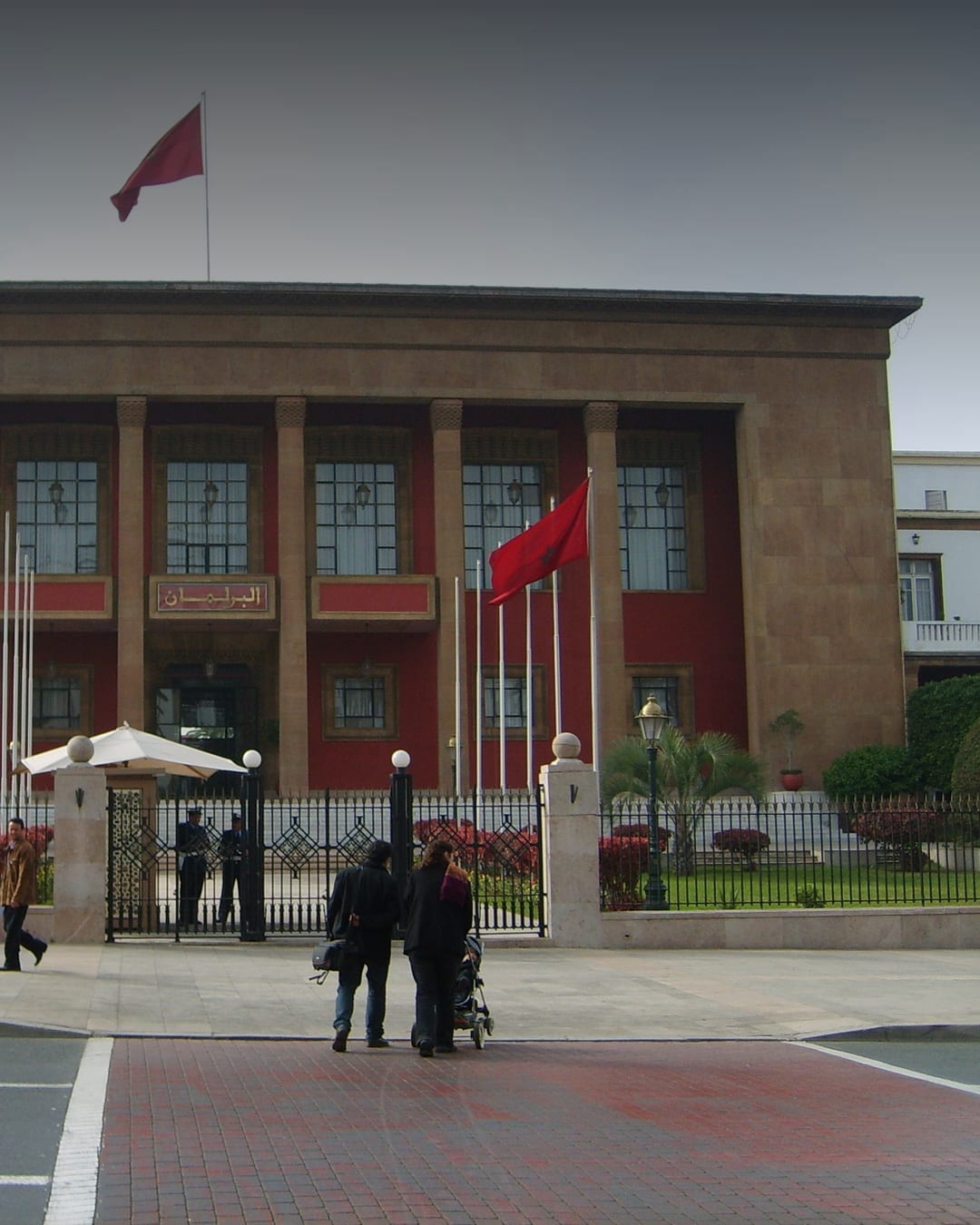 Moroccan Parliament building in Rabat with national flags outside